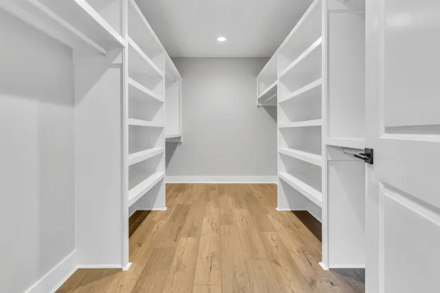 a view of walk in closet with empty racks