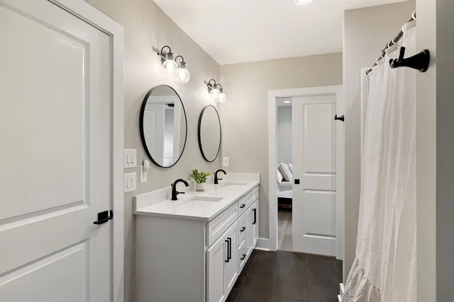 a bathroom with a double vanity sink and a mirror