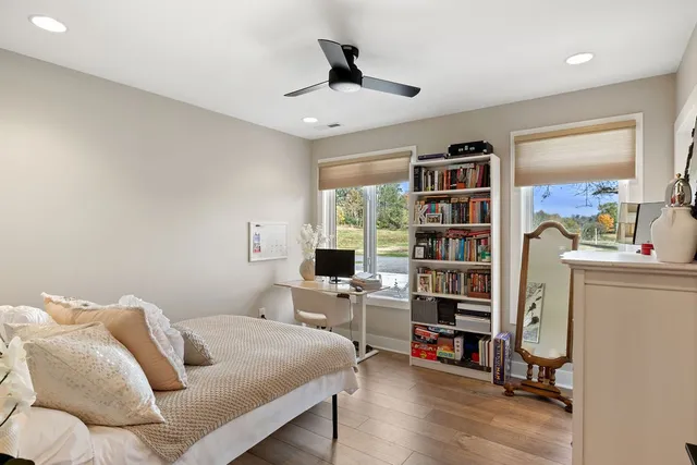 a bedroom with furniture and a book shelf