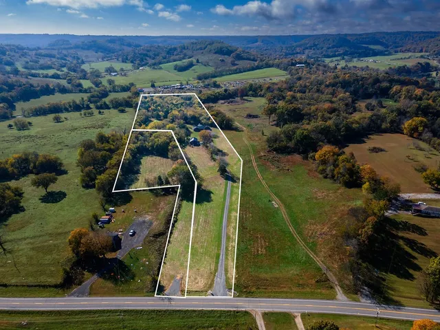 an aerial view of houses with a yard