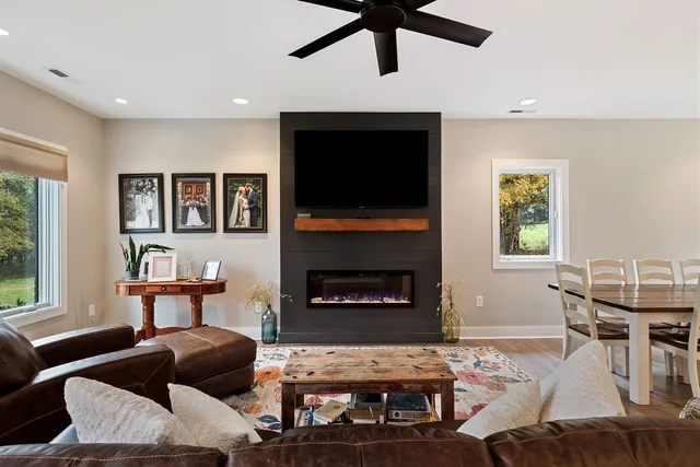 a living room with furniture and a fireplace