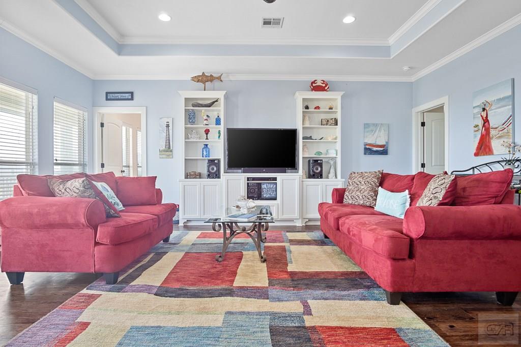 437 Atkinson Street Crystal Beach, TX 77650 - Photo 12 of 40 a living room with furniture and a flat screen tv