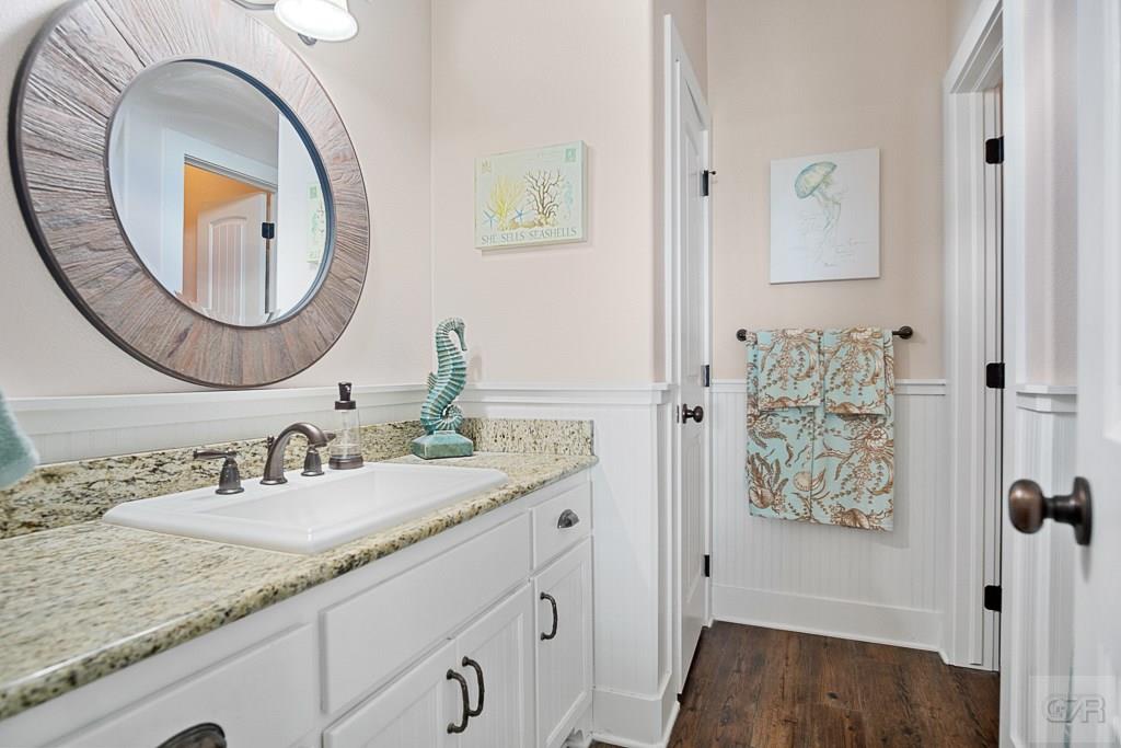 437 Atkinson Street Crystal Beach, TX 77650 - Photo 16 of 40 a bathroom with a granite countertop sink and a mirror