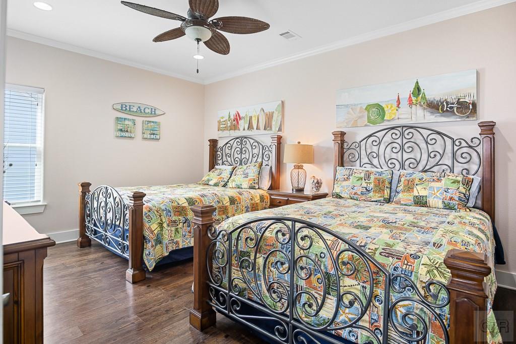 437 Atkinson Street Crystal Beach, TX 77650 - Photo 18 of 40 a bedroom with a bed and a table in it