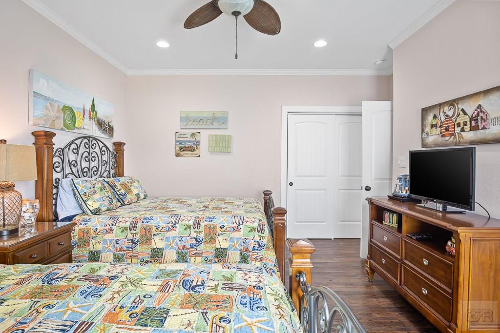 437 Atkinson Street Crystal Beach, TX 77650 - Photo 19 of 40 a bedroom with a bed and flat screen tv