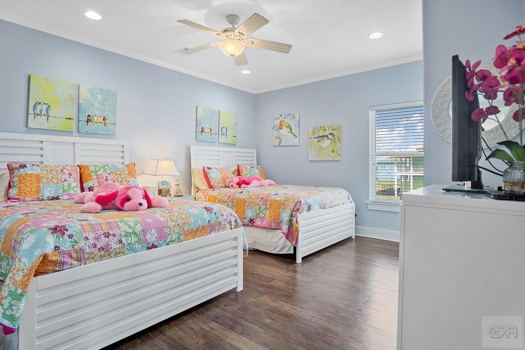 437 Atkinson Street Crystal Beach, TX 77650 - Photo 20 of 40 a bedroom with two beds and a potted plant