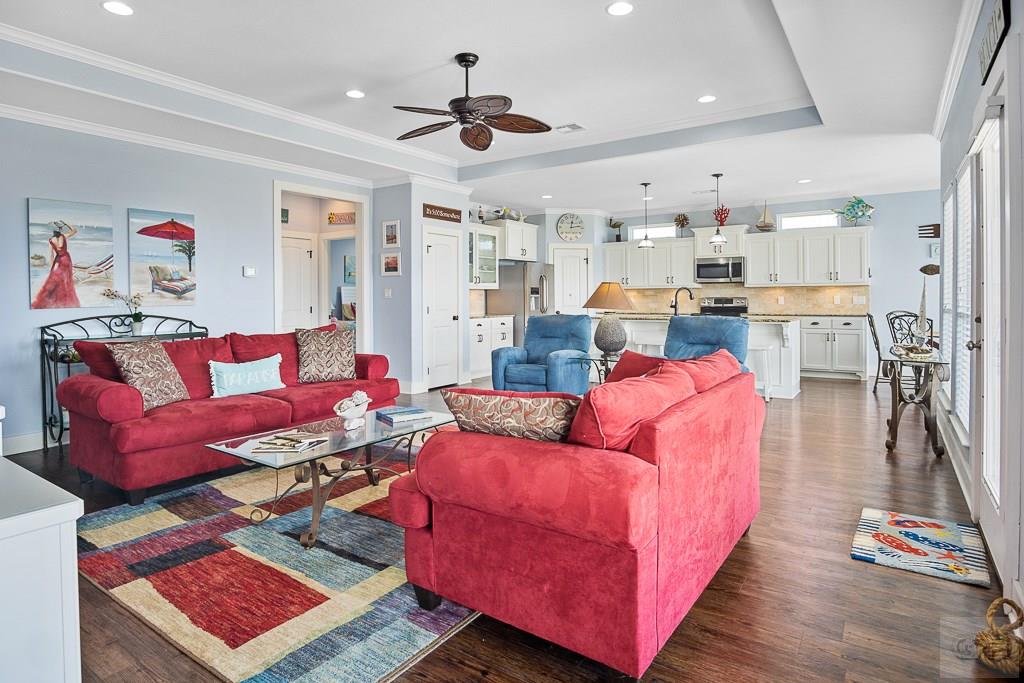437 Atkinson Street Crystal Beach, TX 77650 - Photo 2 of 40 a living room with furniture and a flat screen tv