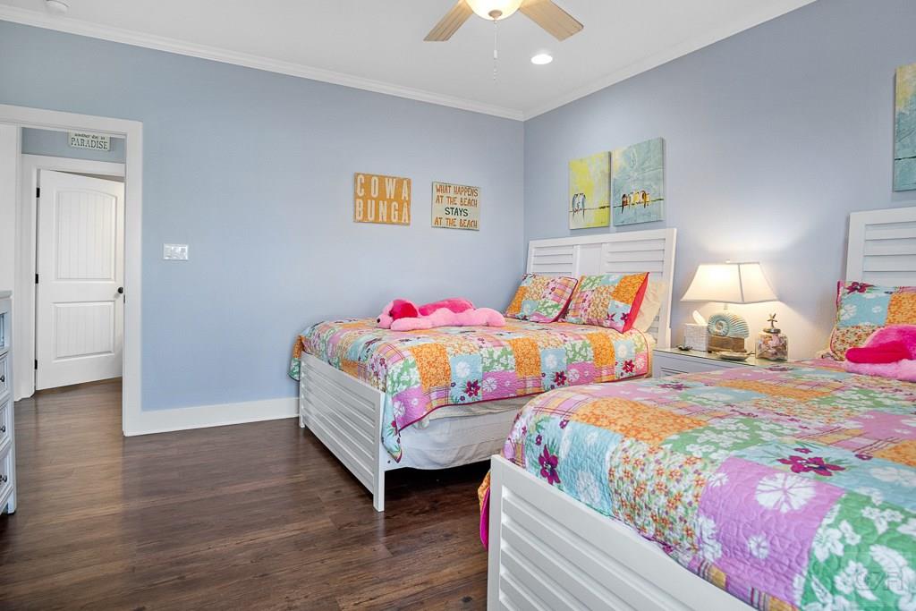 437 Atkinson Street Crystal Beach, TX 77650 - Photo 21 of 40 a bedroom with two beds and painting on the wall