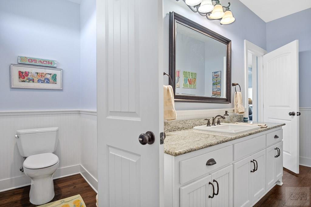437 Atkinson Street Crystal Beach, TX 77650 - Photo 23 of 40 a bathroom with a granite countertop sink toilet and mirror