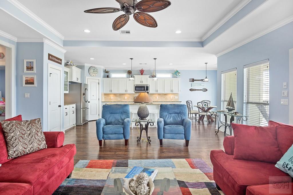437 Atkinson Street Crystal Beach, TX 77650 - Photo 3 of 40 a living room with furniture kitchen view and a chandelier