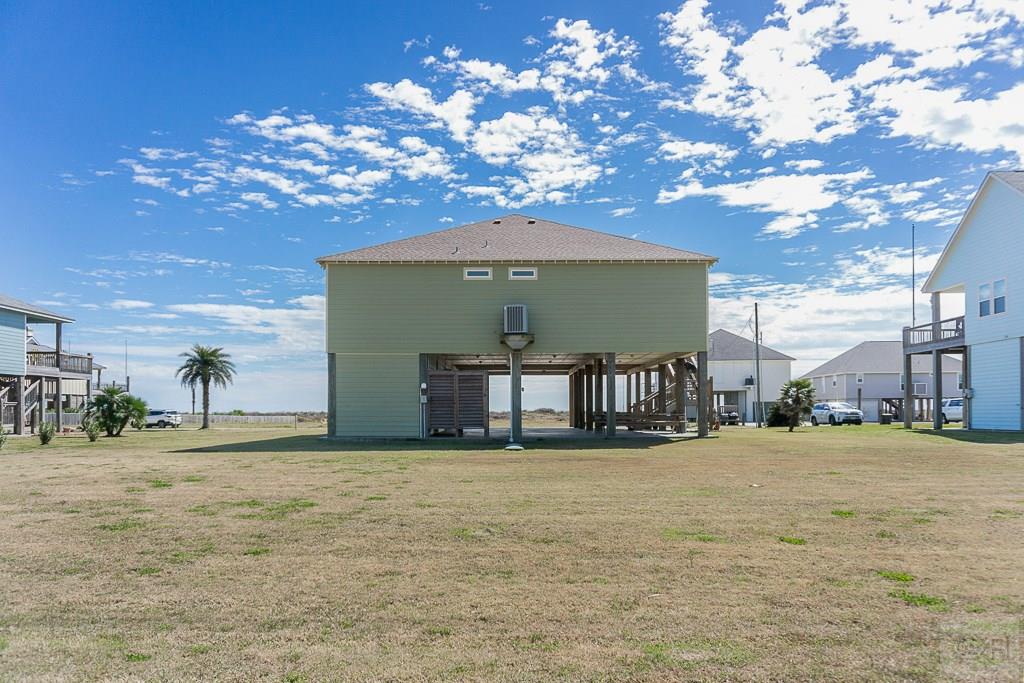 437 Atkinson Street Crystal Beach, TX 77650 - Photo 35 of 40 a view of a house with a yard