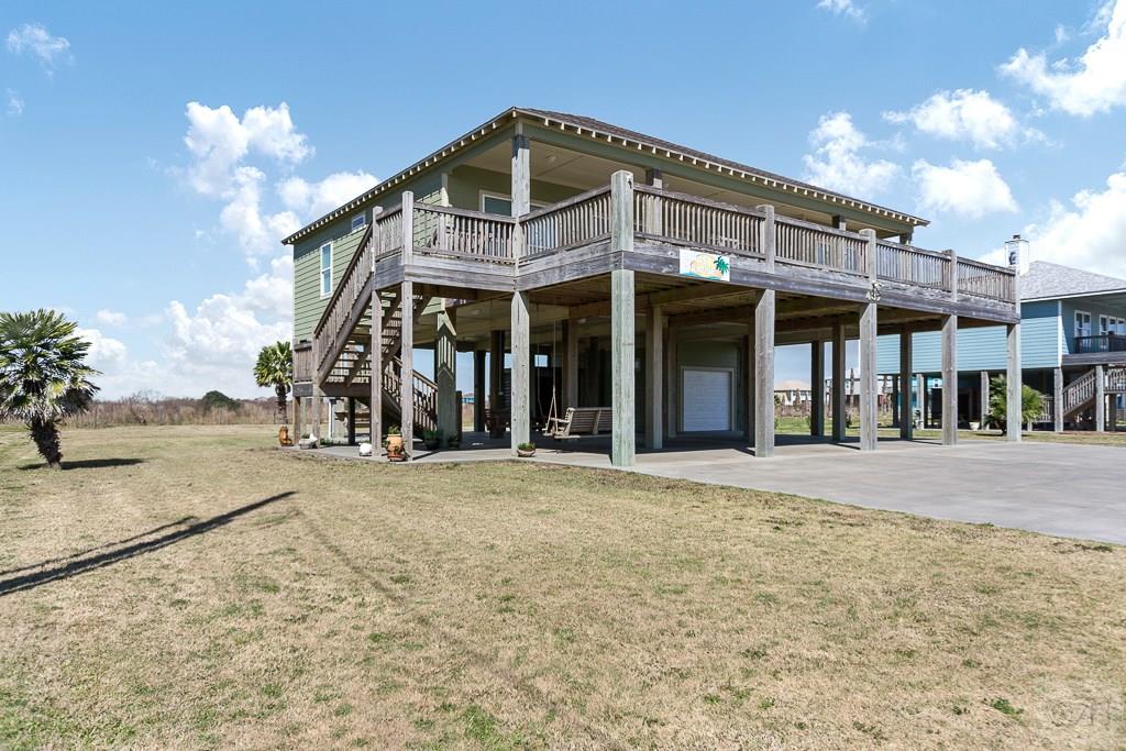 437 Atkinson Street Crystal Beach, TX 77650 - Photo 38 of 40 a front view of a building with a garden