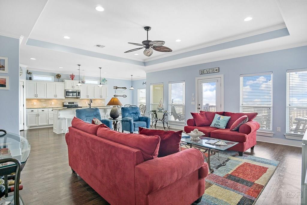 437 Atkinson Street Crystal Beach, TX 77650 - Photo 4 of 40 a living room with furniture kitchen view and a chandelier
