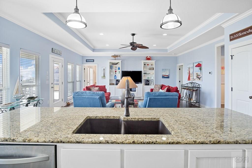437 Atkinson Street Crystal Beach, TX 77650 - Photo 9 of 40 a kitchen with kitchen island granite countertop a sink a counter and window