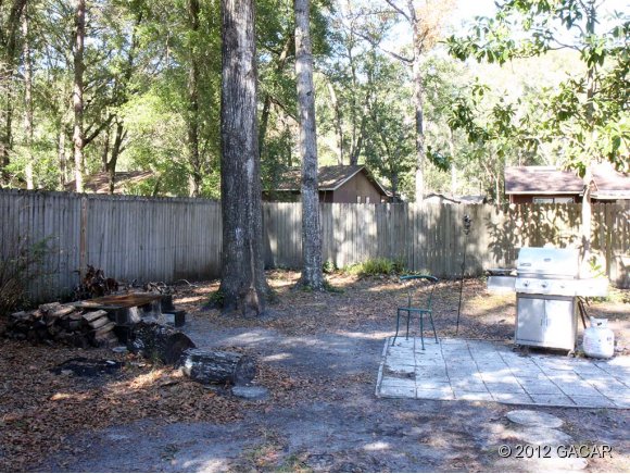 7610 Southwest 7th Place Gainesville, FL 32607 - Photo 10 of 24 Granite fire pit and grill pad