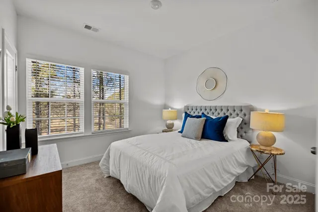 a bedroom with a bed and a lamp