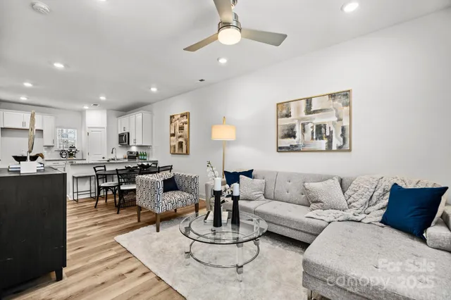 a living room with furniture kitchen view and a table