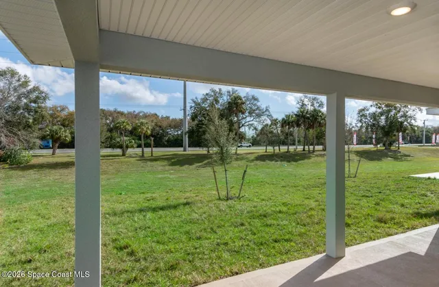 a view of green field with a big yard