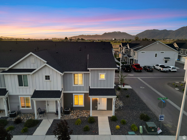1223 East 1775 North Payson, UT 84651 - Photo 10 of 45 Modern townhome exterior featuring light gray and white siding, a dark shingle roof, and a welcoming covered porch entry
