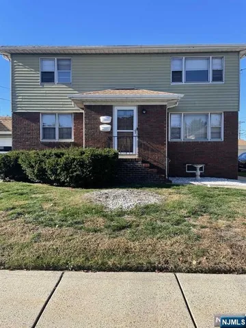a view of a brick house with a yard