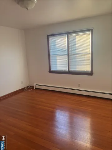 a view of a room with wooden floor and fan