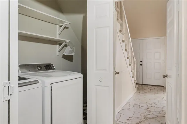 a view of storage and utility room with washer and dryer