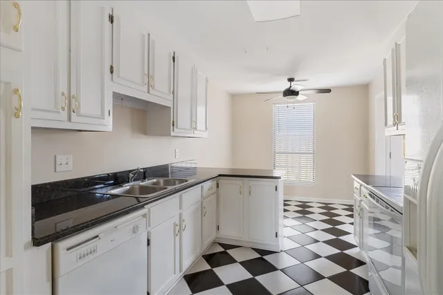 a kitchen with a sink a stove and cabinets