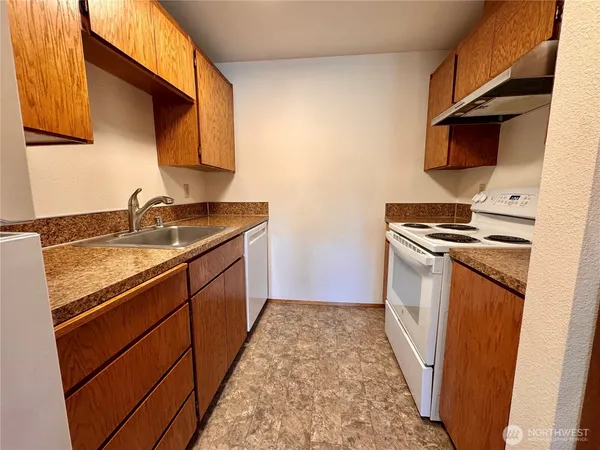 a kitchen with sink a microwave a stove and refrigerator