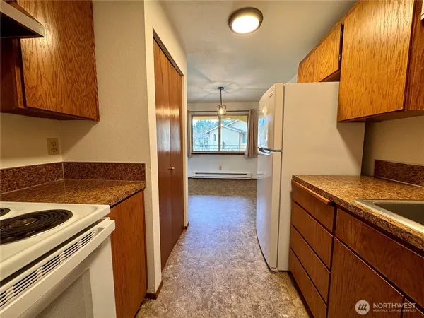 a kitchen with a refrigerator sink and stove