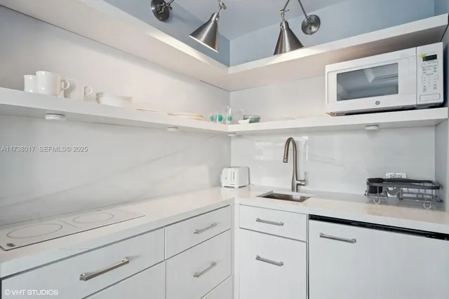 a kitchen with a sink and cabinets