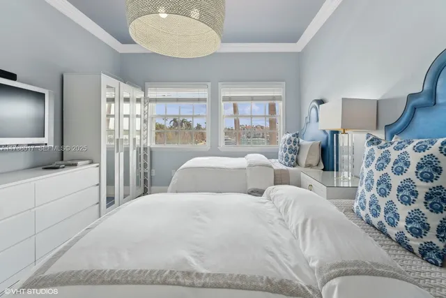 a large bedroom with a large bed and flat screen tv