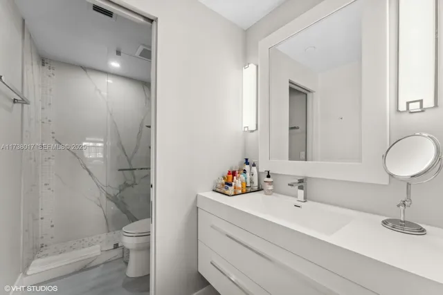 a bathroom with a sink toilet and shower
