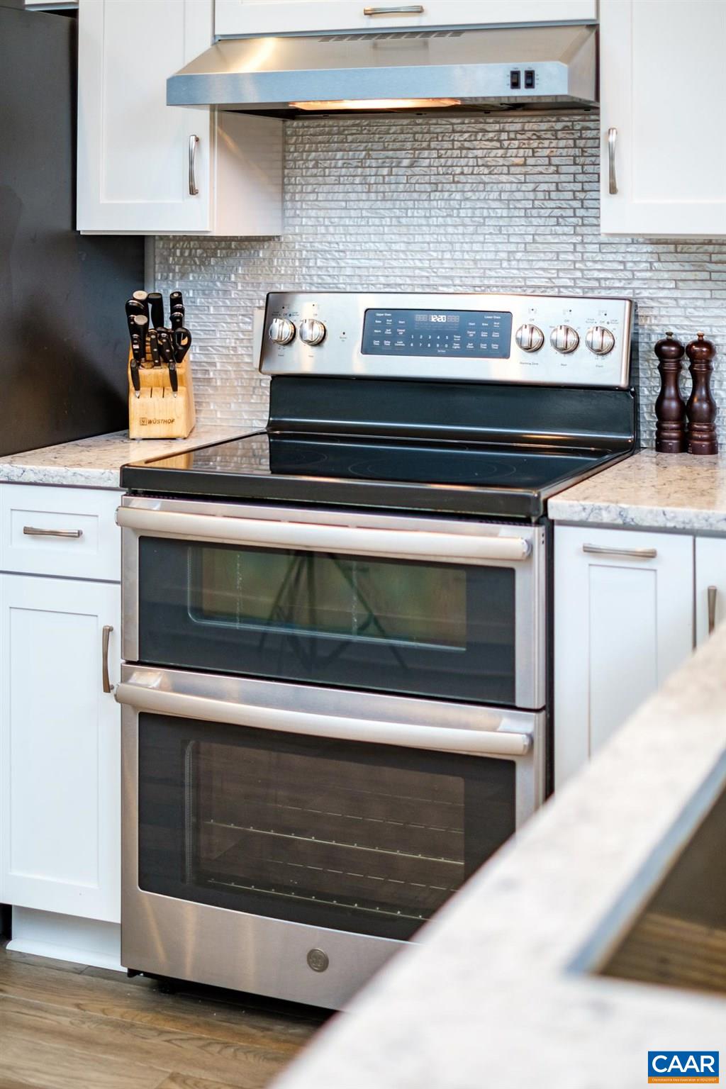 265 Turkey Ridge Road Charlottesville, VA 22903 - Photo 4 of 57 a stove top oven sitting inside of a kitchen