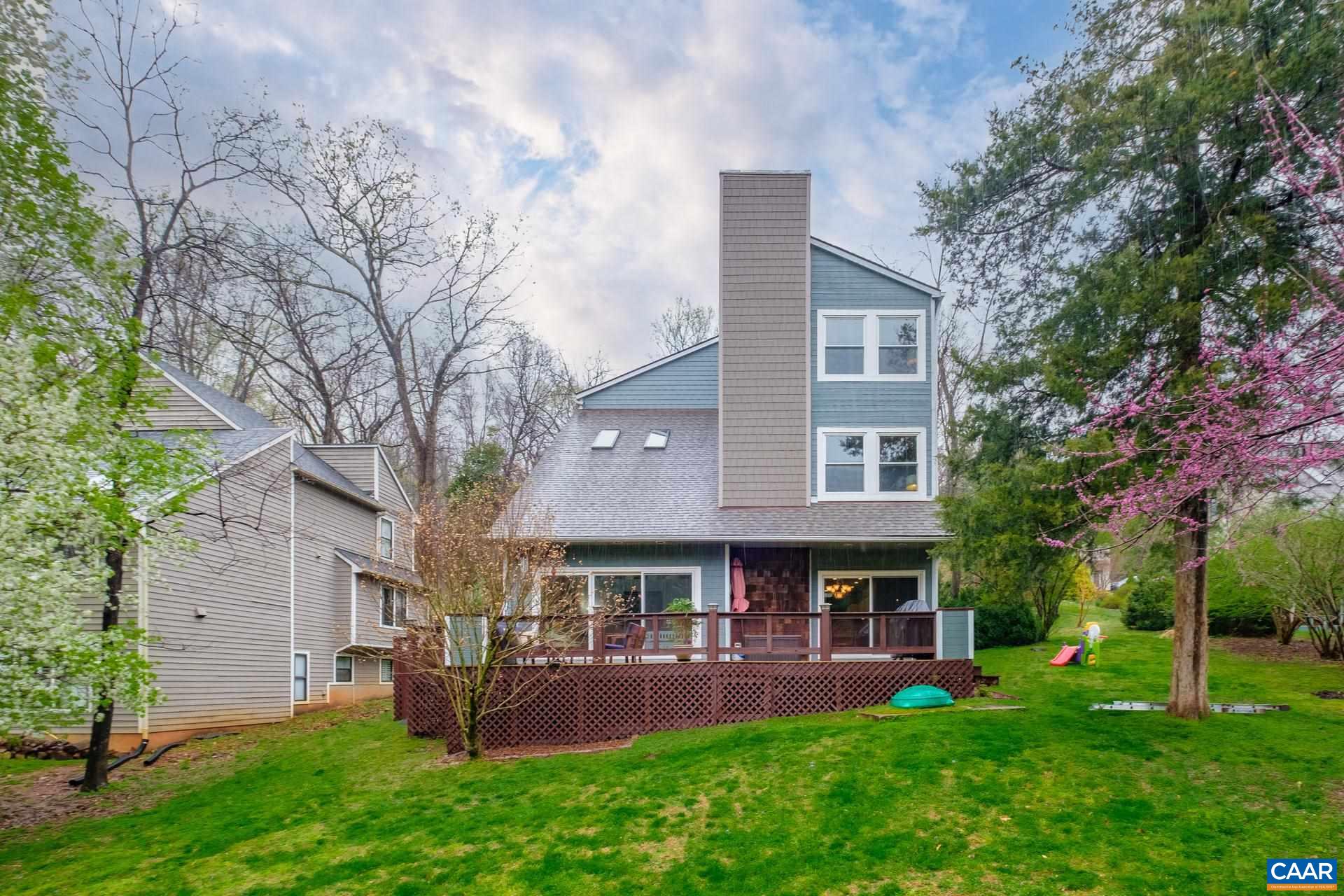 265 Turkey Ridge Road Charlottesville, VA 22903 - Photo 50 of 57 a view of a yard with table and chairs and potted plants and large trees