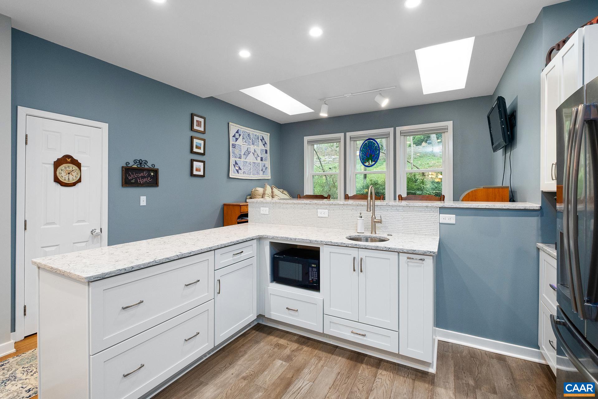 265 Turkey Ridge Road Charlottesville, VA 22903 - Photo 6 of 57 a view of a kitchen counter space with furniture and windows