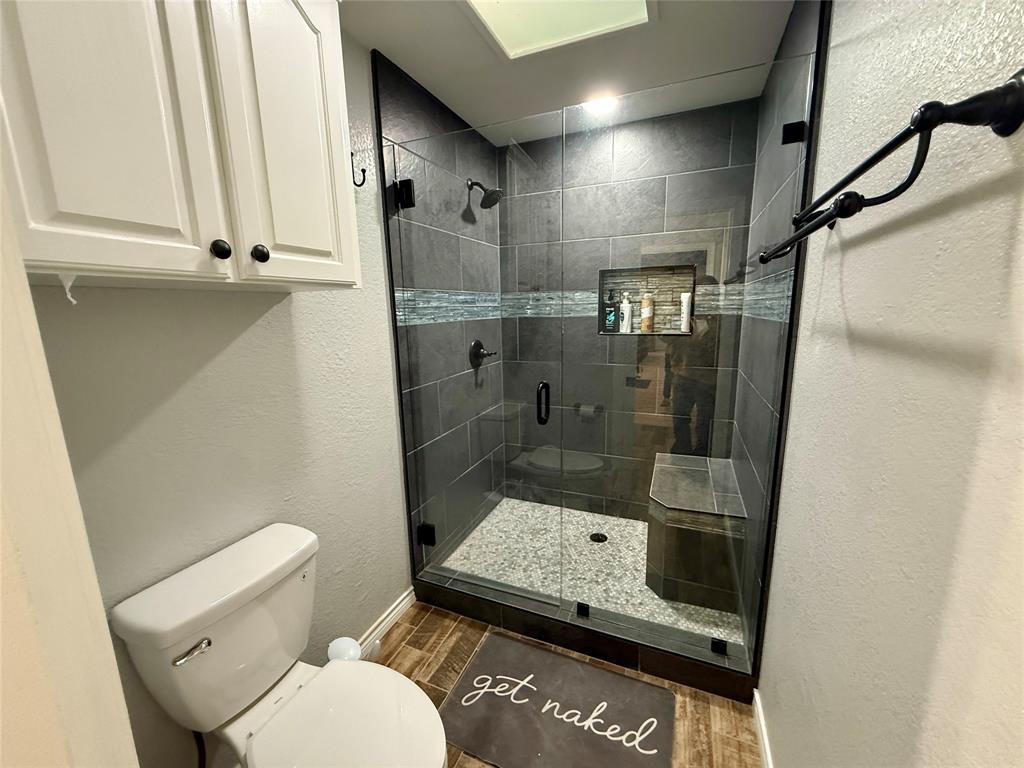 2007 Deep Water Road May, TX 76857 - Photo 14 of 40 a bathroom with a toilet and a shower