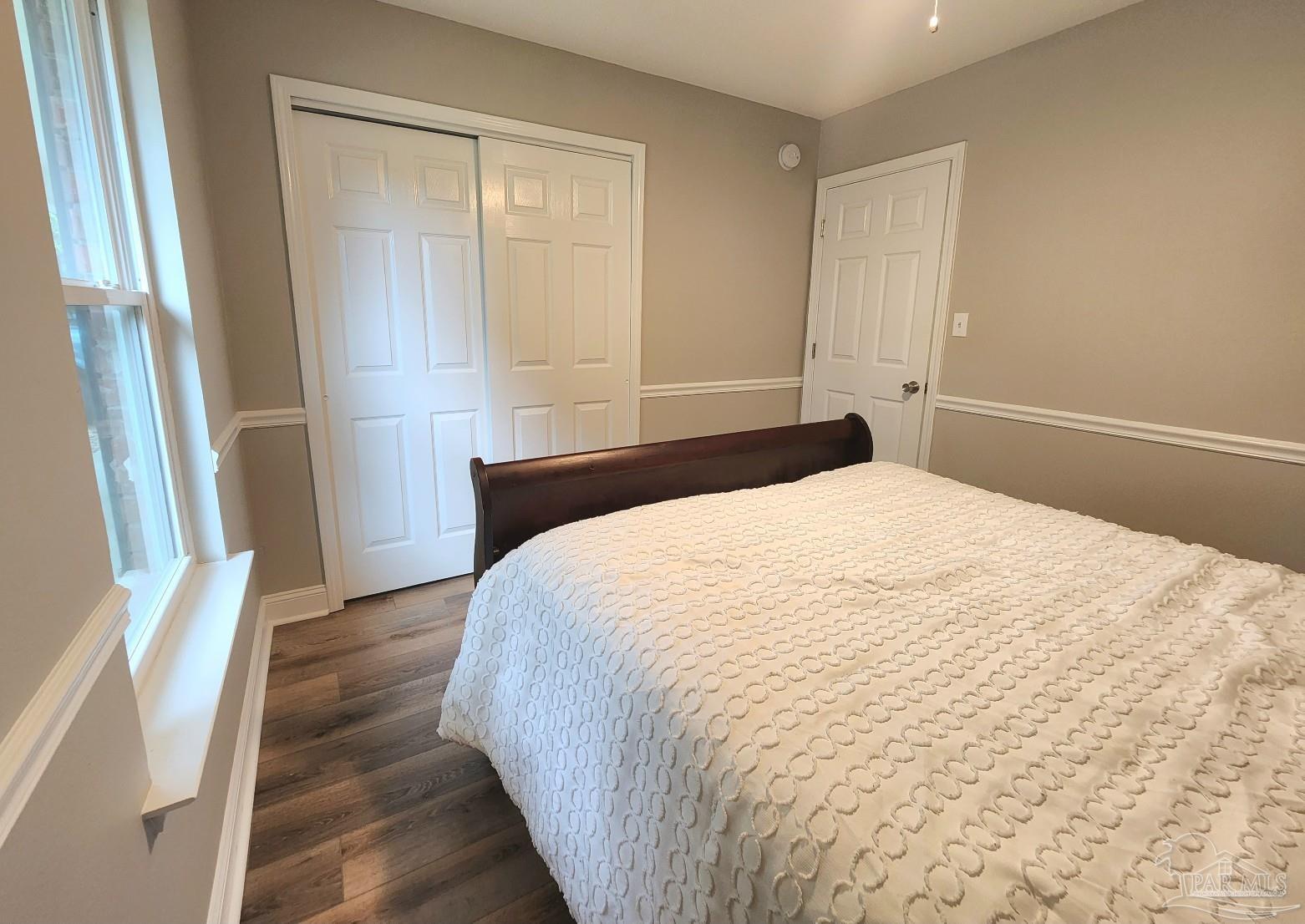 4348 Wellington Drive Pace, FL 32571 - Photo 16 of 20 a bedroom with a bed and a mirror