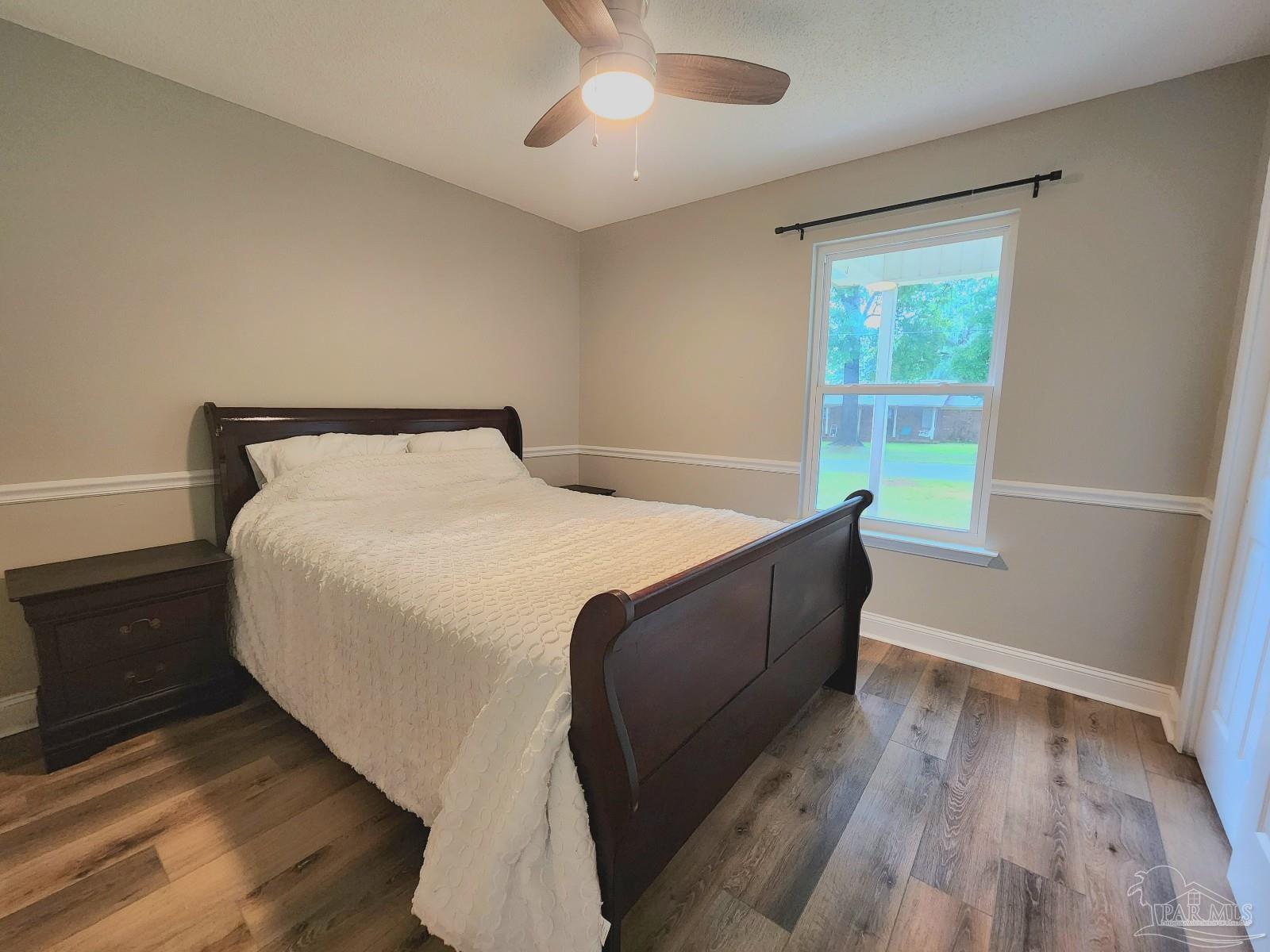 4348 Wellington Drive Pace, FL 32571 - Photo 17 of 20 a bed sitting in a bedroom next to a window