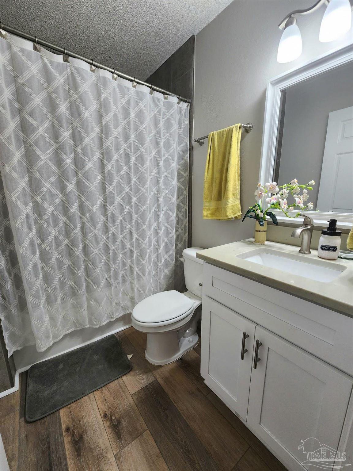 4348 Wellington Drive Pace, FL 32571 - Photo 18 of 20 a bathroom with a granite countertop sink and a mirror