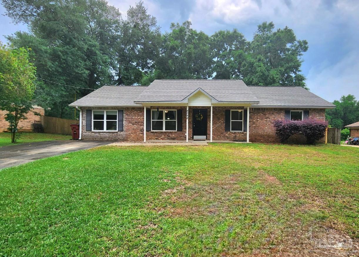 4348 Wellington Drive Pace, FL 32571 - Photo 2 of 20 a front view of a house with a yard