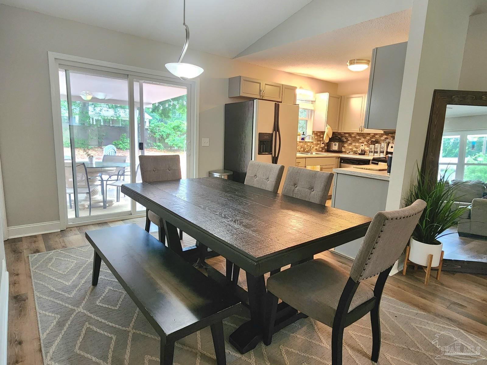 4348 Wellington Drive Pace, FL 32571 - Photo 4 of 20 a view of a dining room with furniture window and wooden floor