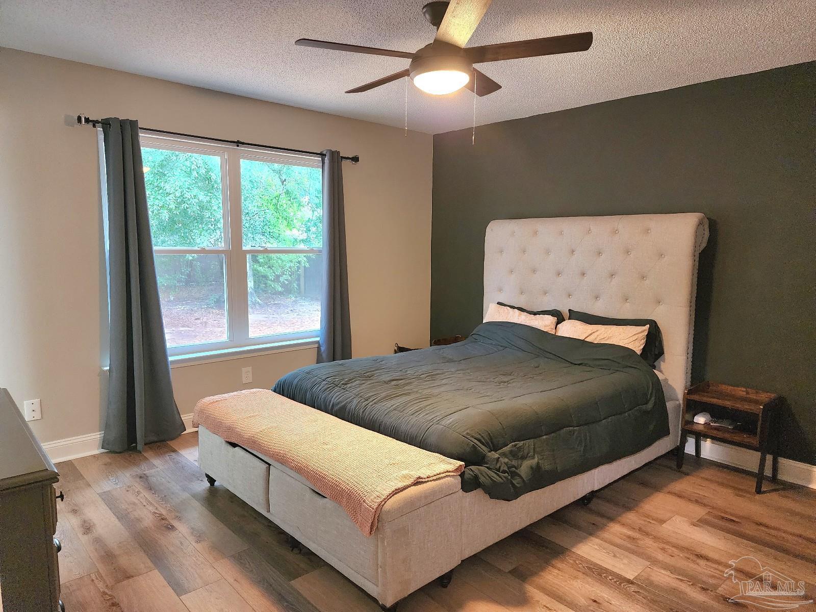 4348 Wellington Drive Pace, FL 32571 - Photo 10 of 20 a bed sitting in a bedroom next to a window