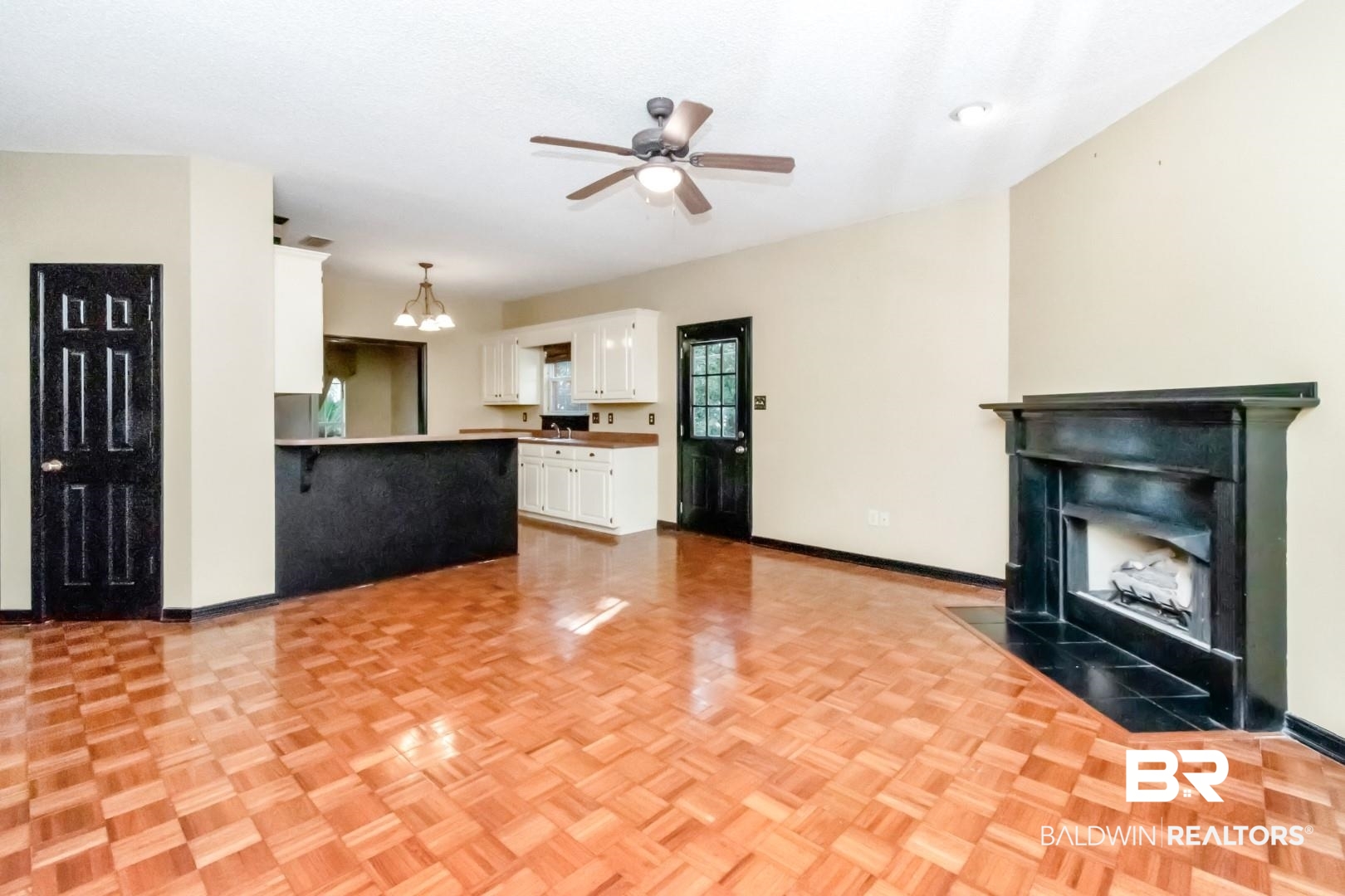 152 Ideal Avenue Mobile, AL 36608 - Photo 17 of 32 Unfurnished living room with ceiling fan with notable chandelier and light parquet flooring