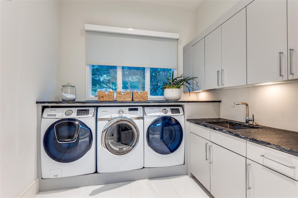 4326 Pomona Road Dallas, TX 75209 - Photo 14 of 31 Washroom featuring washer and dryer and cabinet space