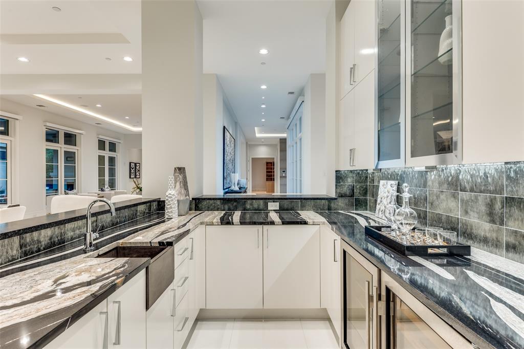 4326 Pomona Road Dallas, TX 75209 - Photo 8 of 31 Kitchen with dark stone countertops, white cabinetry, beverage cooler, glass insert cabinets, and recessed lighting