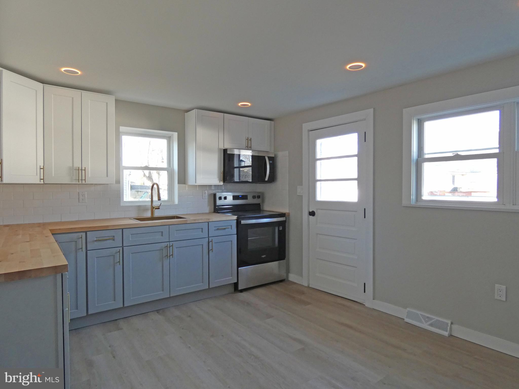 411 Manor Avenue Carneys Point, NJ 08069 - Photo 13 of 50 a kitchen with sink a microwave and cabinets