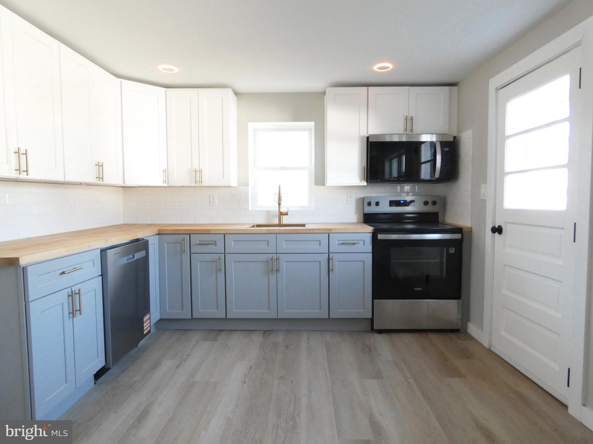 411 Manor Avenue Carneys Point, NJ 08069 - Photo 16 of 50 a kitchen with stainless steel appliances granite countertop a stove a sink dishwasher and a refrigerator
