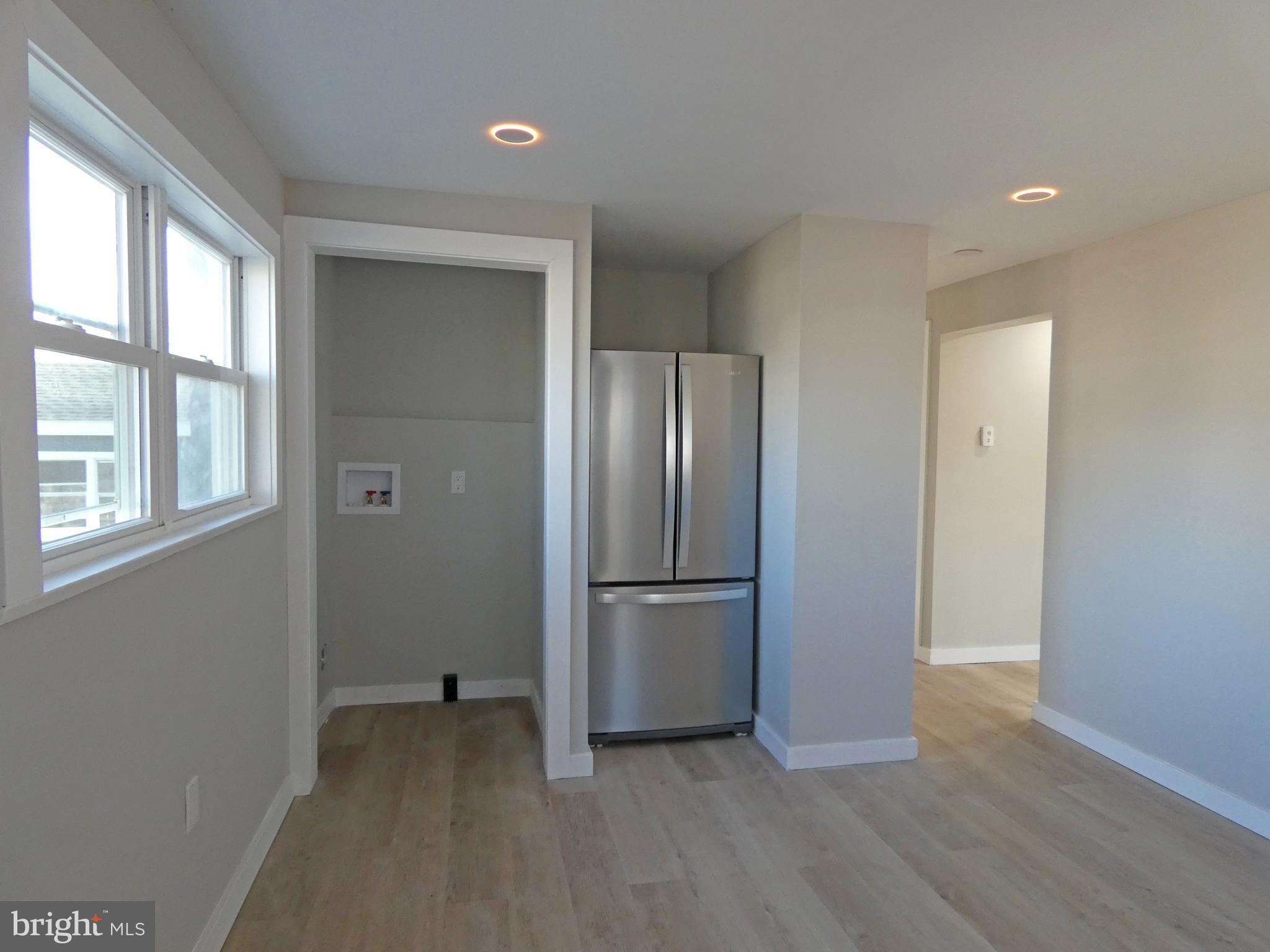 411 Manor Avenue Carneys Point, NJ 08069 - Photo 19 of 50 a view of an empty room with window and refrigerator