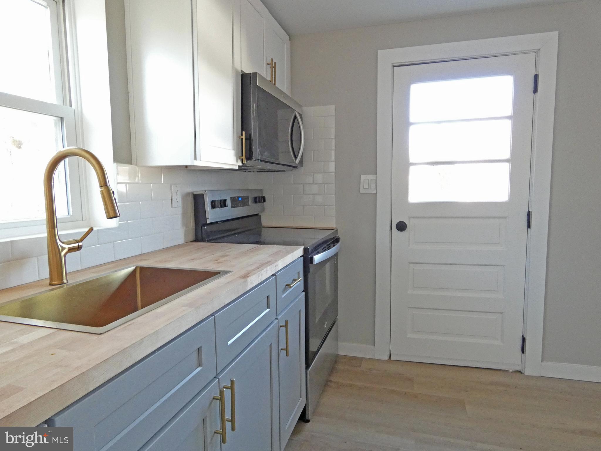 411 Manor Avenue Carneys Point, NJ 08069 - Photo 21 of 50 a view of a kitchen sink with a microwave