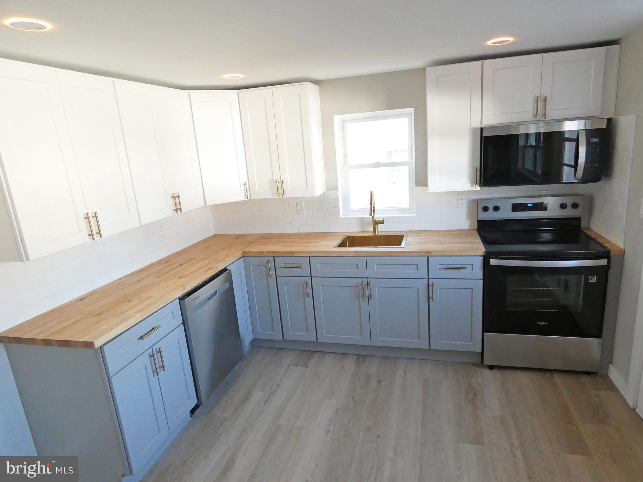 411 Manor Avenue Carneys Point, NJ 08069 - Photo 22 of 50 a kitchen with stainless steel appliances a stove a sink and a microwave